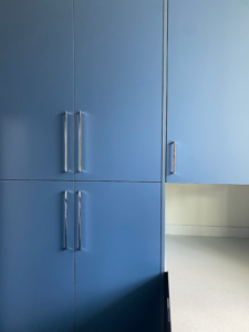 a kitchen with blue cabinets