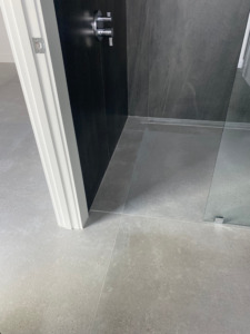 a glass enclosed shower and a sink in a palm beach county bathroom