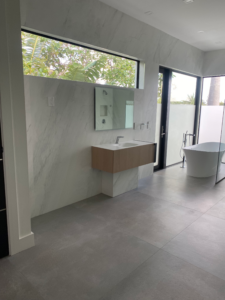 a glass enclosed shower and a sink in a palm beach county bathroom