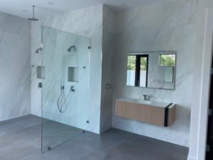a glass enclosed shower in a palm beach county home