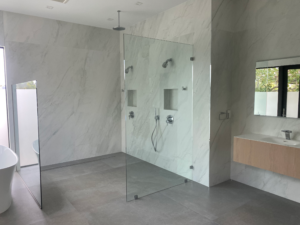 a glass enclosed shower in a palm beach county home