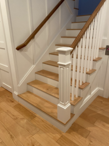 the bottom of a wooden white staircase in boca raton