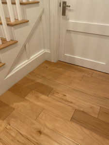 a wooden floor next to a staircase