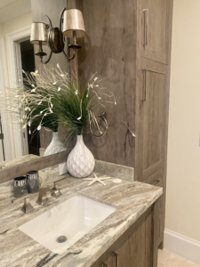 a luxury bathroom with wooden cabinets