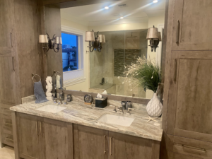 a luxury bathroom with wooden cabinets