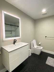 Bathroom remodel featuring new sink, tile, and toilet installation