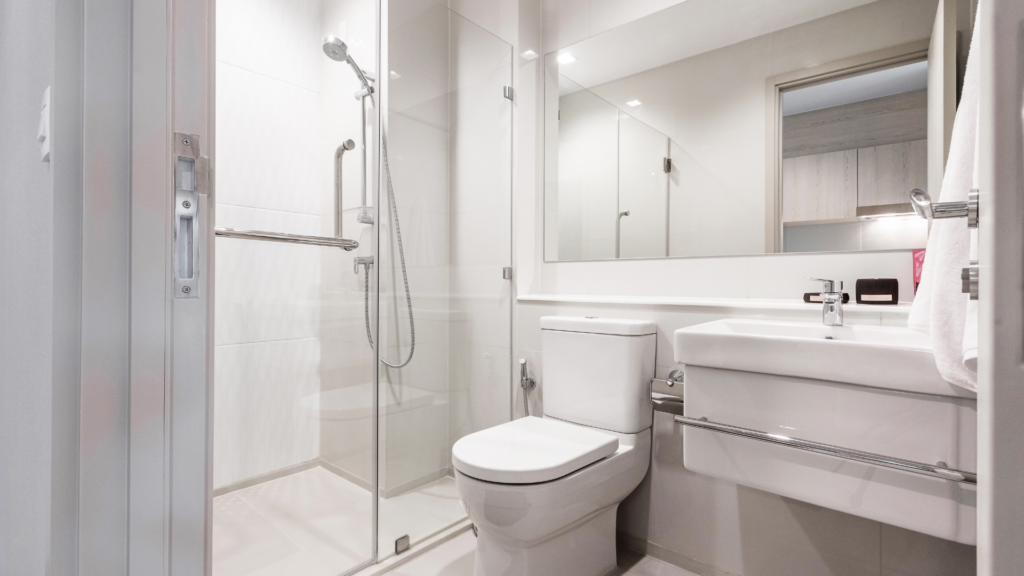 Bright and minimalist bathroom with a walk-in shower, modern toilet, and clean white finishes.