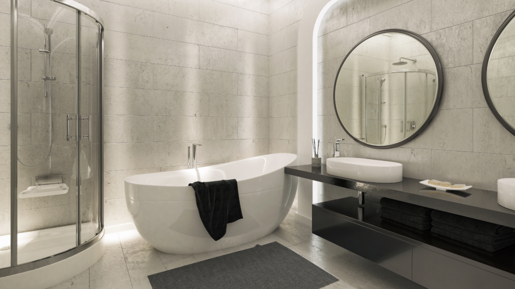 Elegant bathroom with a curved bathtub, glass shower, and double sink vanity under soft lighting.