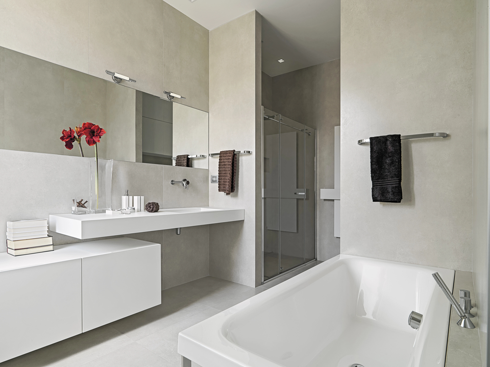 A modern bathroom with modern white features , exhibiting the benefits of a bathroom remodel.