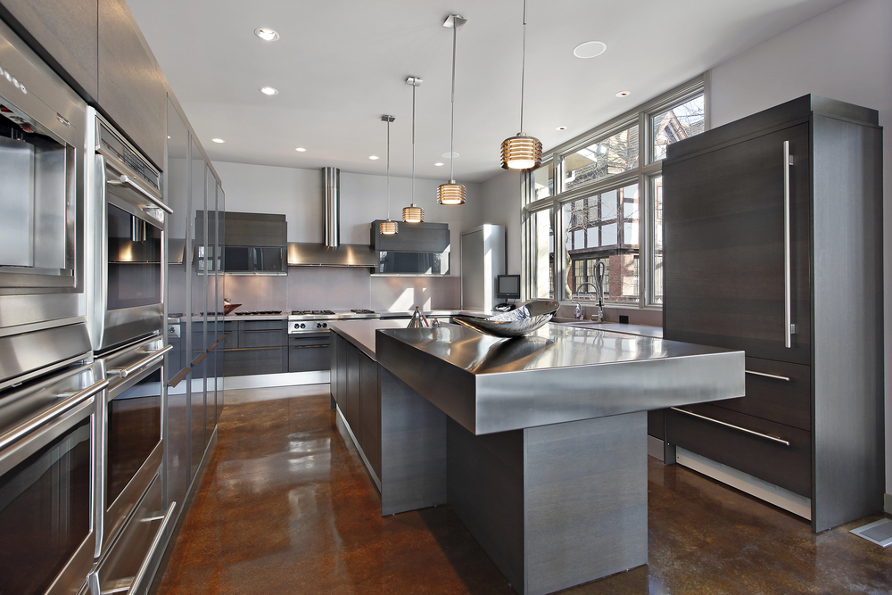 A modern kitchen with dark countertops as part of the 2025 kitchen design trends.